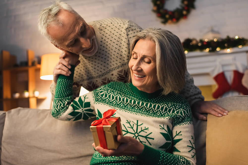 Couple giving each other Christmas gift